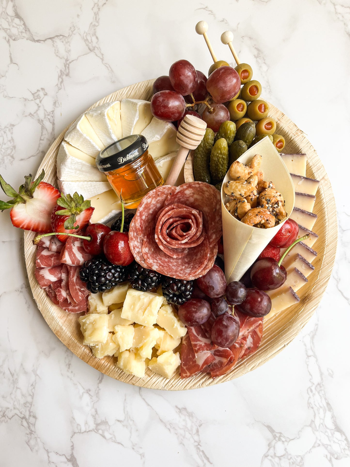 Small charcuterie platter featuring gourmet cheeses, cured meats (salami and coppa), and gourmet accompaniments (nuts, fresh and dried fruit, olives, pickles, and more)! The platter is artfully arranged creating an elegant grazing experience. Sacramento charcuterie catering is available. Whether it's for a party, wedding, or corporate event, you can't go wrong!
