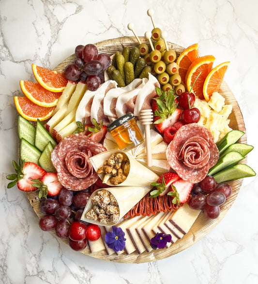 Medium charcuterie platter featuring gourmet cheeses, cured meats (salami varieties and prosciutto), and gourmet accompaniments (nuts, fresh and dried fruit, olives, pickles, and more)! The platter is artfully arranged creating an elegant grazing experience. Sacramento charcuterie catering is available. Whether it's for a party, wedding, or corporate event, you can't go wrong! 