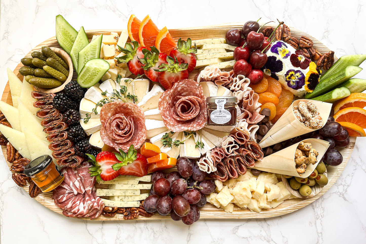 XL charcuterie platter featuring gourmet cheeses, cured meats (salami, prosciutto, and coppa), and gourmet accompaniments (nuts, dried fruit, olives, pickles, and more)! The platter is artfully arranged creating an elegant grazing experience. Sacramento charcuterie catering is available. Whether it's for a party, wedding, or corporate event, you can't go wrong! 